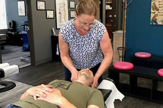 Chiropractor Tigard OR Kimberly Guthrie Adjusting Patient